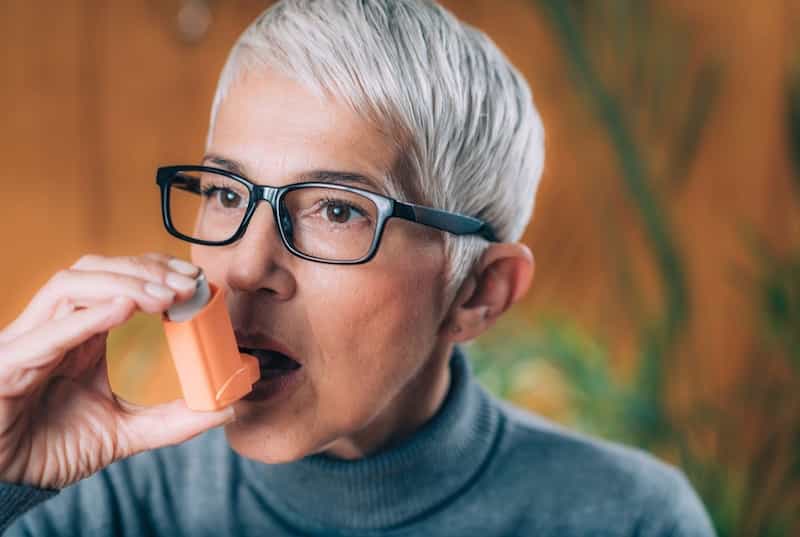 elderly woman with inhaler